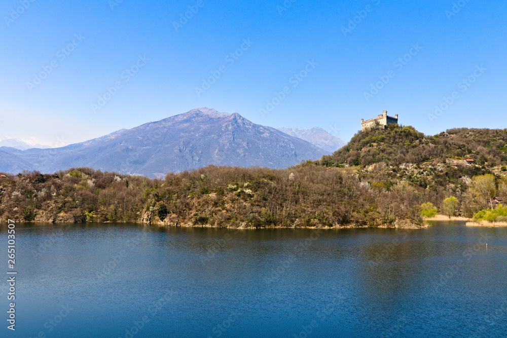 The castle of Montalto Dora, at an altitude of 405 meters, on the Pistono Lake, in the morainic amphitheater of Ivrea, dating back to the mid-12th century.  Clear sunny spring morning