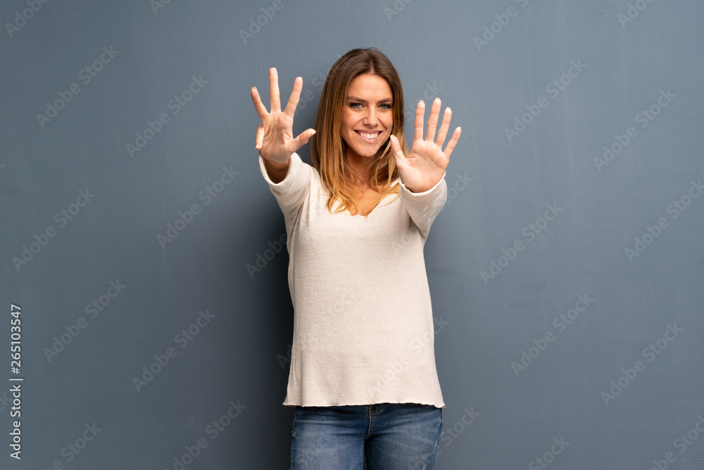 Blonde woman over grey background counting nine with fingers Blonde woman over grey background counting nine with fingers