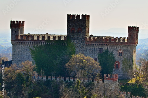 The castle of Montalto Dora, at an altitude of 405 meters, on the Pistono Lake, in the morainic amphitheater of Ivrea, dating back to the mid-12th century.  Clear sunny spring morning photo