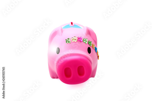 A pink pig plastic coin bank isolated white at the studio.