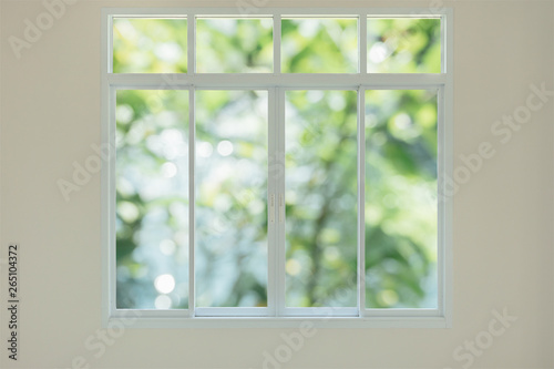 Obraz na plátně Modern house window with green garden view bokeh background
