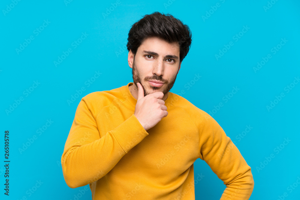 Handsome over isolated blue wall thinking Handsome over isolated blue wall thinking