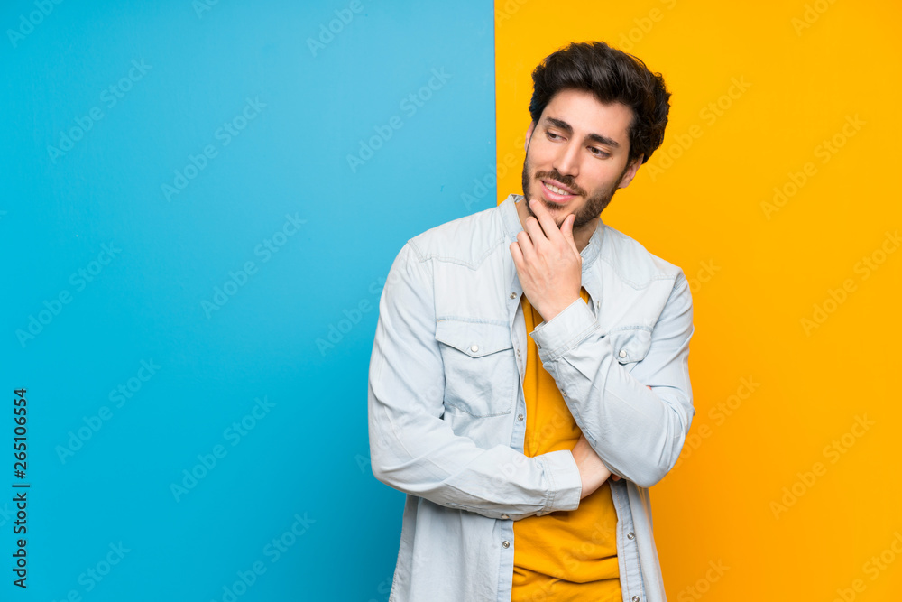 Handsome over isolated colorful background looking to the side Handsome over isolated colorful background looking to the side