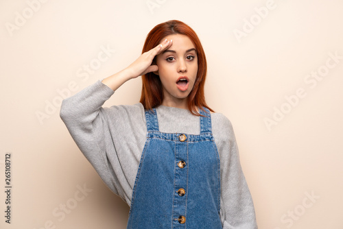 Young redhead woman over isolated background has just realized something and has intending the solution