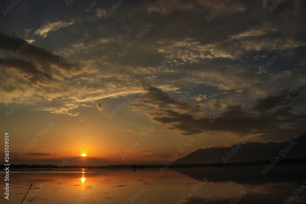 A beautiful sunset on the Dal Lake in Kashmir. Reflections in the Dal Lake