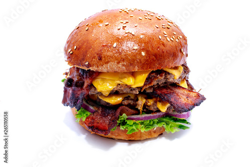 Juicy beef burger with bacon, cheese and salad. Close-up.