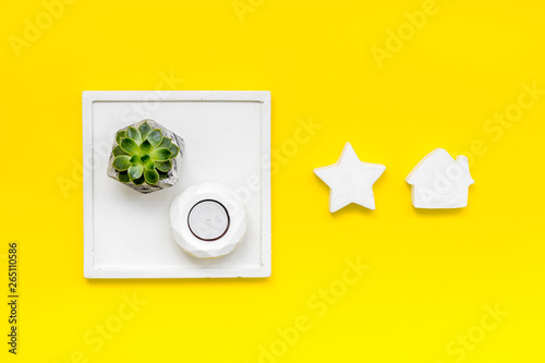 concrete figures and tray decorations for morden home office on yellow background flat lay
