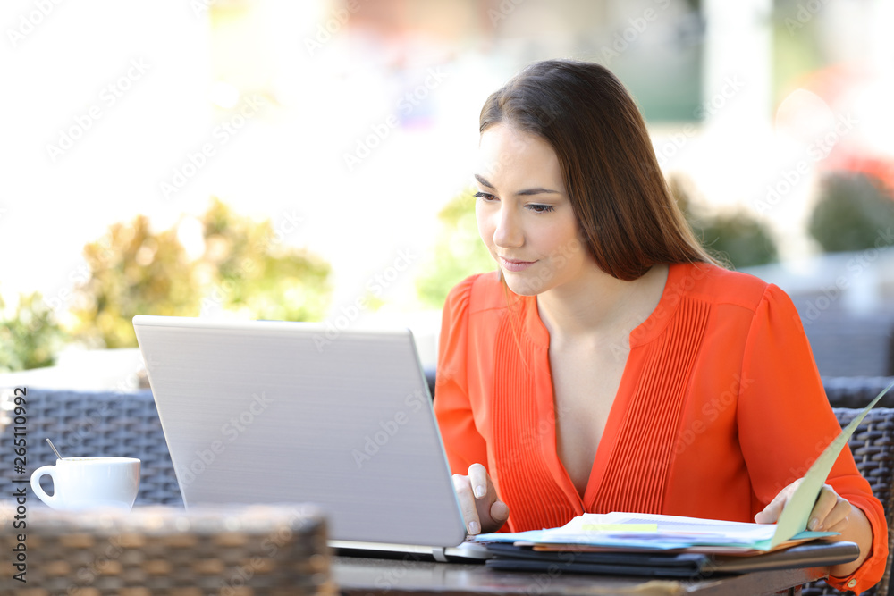 Serious entrepreneur working online in a coffee shop Serious entrepreneur working online in a coffee shop