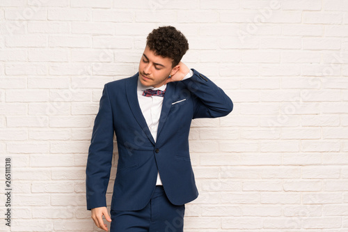 Man in suit and bow tie with neckache