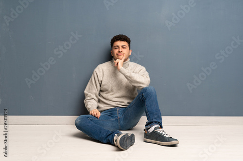 Young man sitting on the floor Looking front