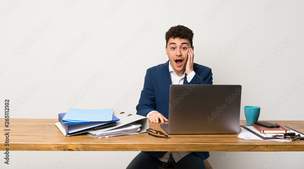 Business man in a office with surprise and shocked facial expression Business man in a office with surprise and shocked facial expression