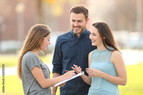 Happy couple asking a survey in the street