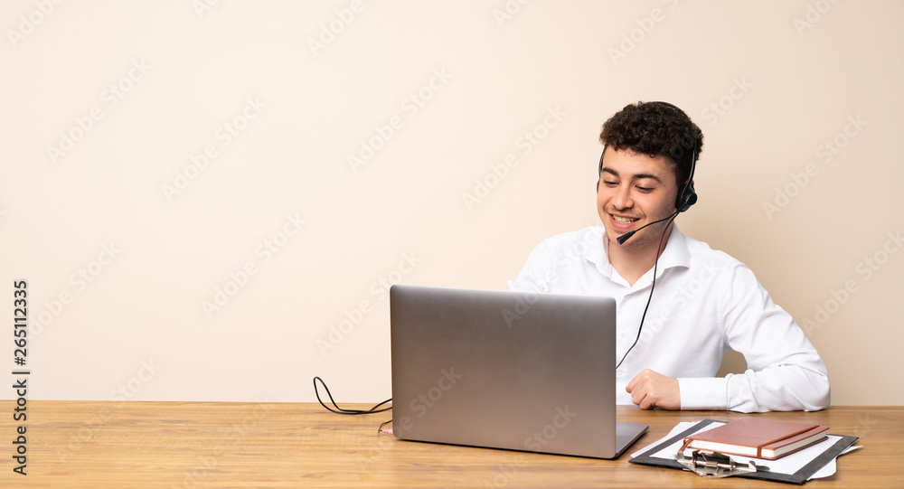Telemarketer man posing with arms at hip and smiling Telemarketer man posing with arms at hip and smiling