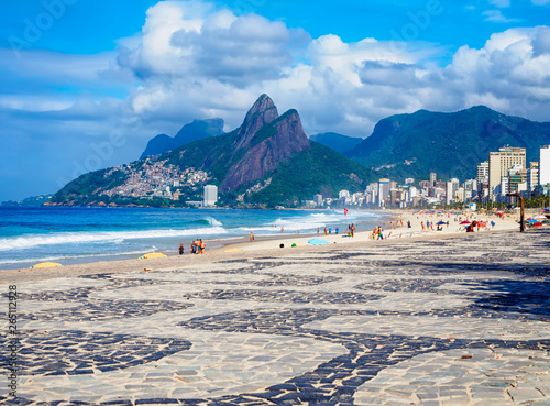 Ipanema beach with mosaic of sidewalk and mountain Dois Irmao (Two Brother)  in Rio de Janeiro, Brazil photo