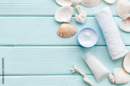 cosmetics with Dead Sea minerals and shells on mint green wooden background top view copy space