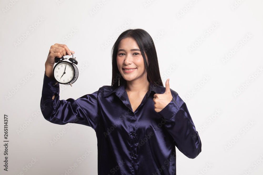 Young Asian woman show thumbs up with a clock.