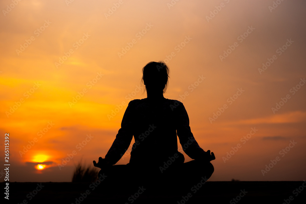 YOGA Silhouette woman sitting area meditating in sunset - Image