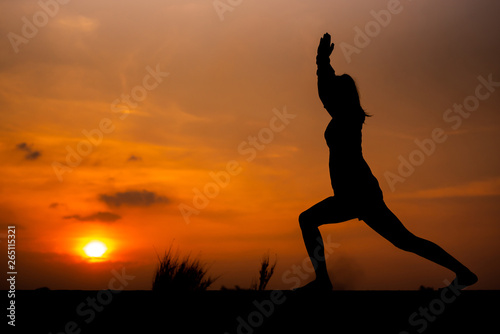 Silhouette Asia woman yoga on sunset. - Image