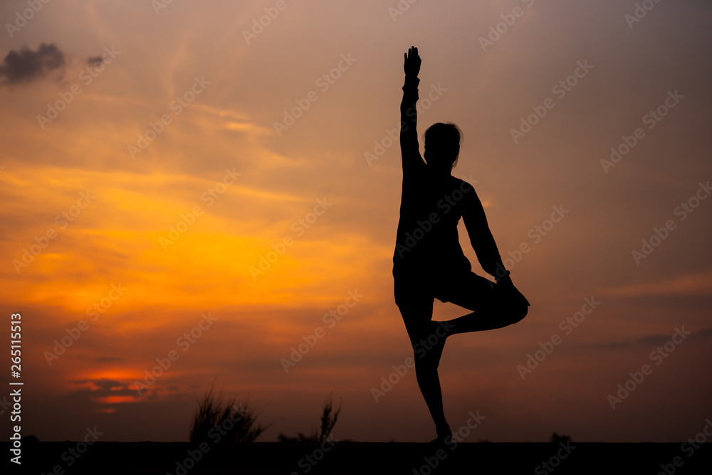 Silhouette Asia woman yoga on sunset. - Image