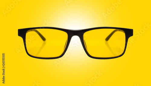 Single sunglasses with black plastic frame and yellow glass