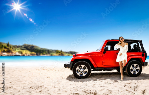 Slim young woman in summer dress and red car on beach. Free space for your decoration. © magdal3na