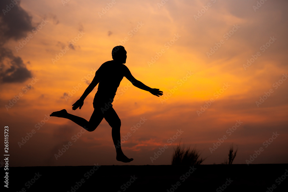 Man running alone at beautiful sunset in the road at park . Summer sport and freedom concept. Athlete training on dusk. - Image Man running alone at beautiful sunset in the road at park . Summer sport and freedom concept. Athlete training on dusk. - Image