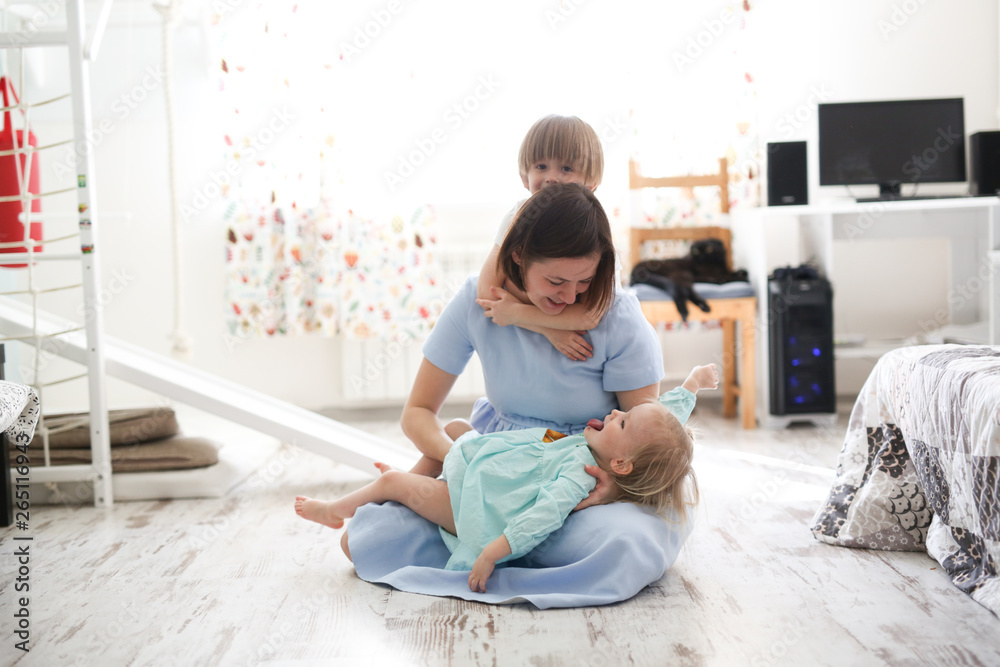 mom with siblings children embraces and holds them mom with siblings children embraces and holds them