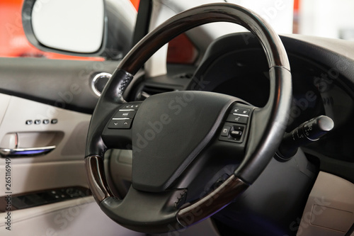 View to the black color interior of suv car with front seats, steering wheel and dashboard with gray leather upholstery after cleaning and detailing in vehicle repair workshop. Auto service industry.