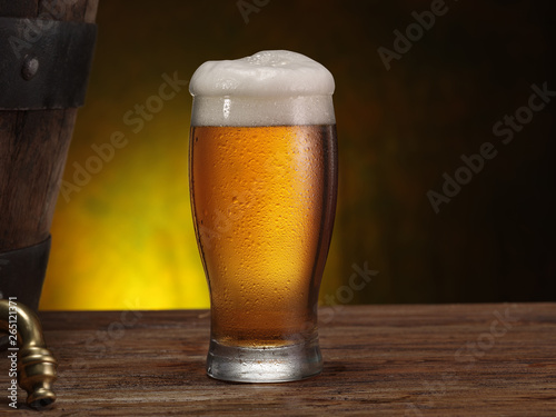 Chilled glass of beer on the wooden table. Close-up. Craft brewery.