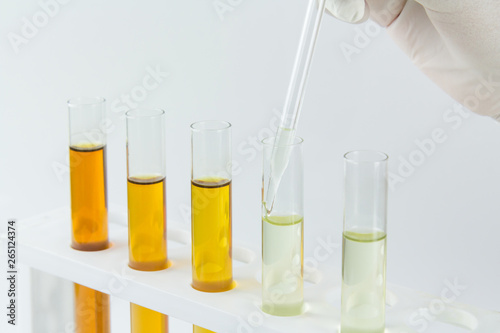 Photography oil in glass tube on white background