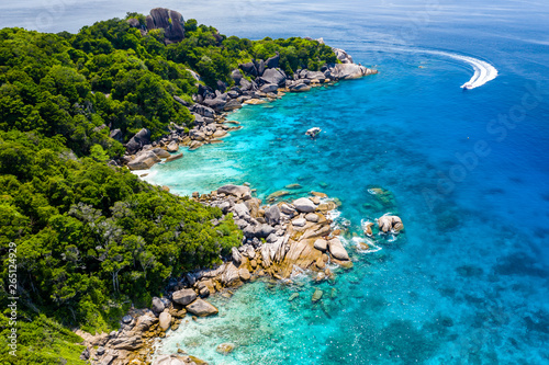 Aerial drone view of boats and coral reef around beautiful tropical islands in a warm ocean