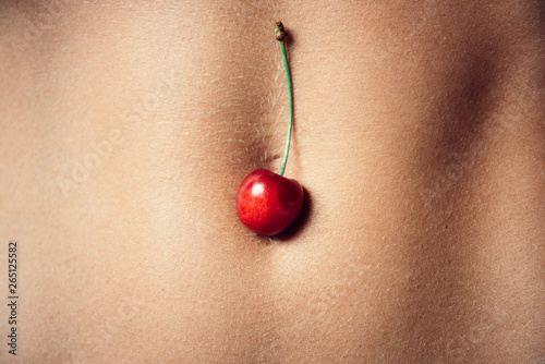 Love game. Fit woman body. Cherry fruit. Sensual concept. Sexuality. Beautiful girl. Hot Sexy detail of a girl body. Naked sensual beautiful girl. Summer fruit. Erotic couple. Beautiful Female Body