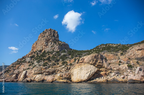 Beautiful view from water at yellow and orange Crimean mountain landscape near Balaklava at sea coast. Summer travel and journey © DedMityay