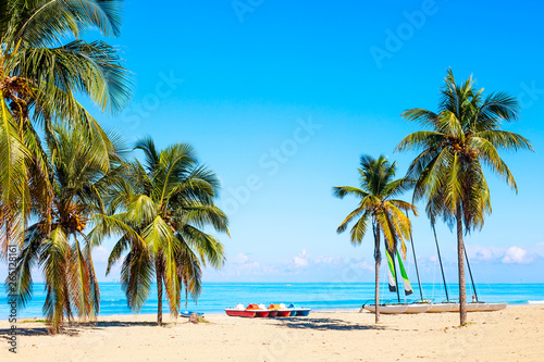 The tropical beach of Varadero in Cuba with sailboats and palm trees on a summer day with turquoise water. Vacation background. © Nikolay N. Antonov