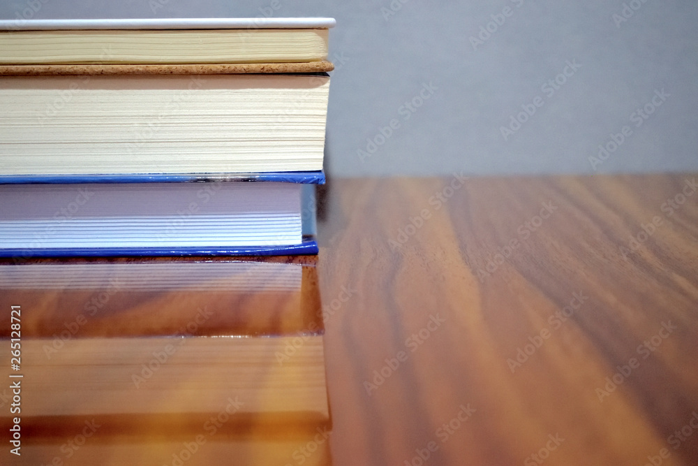 group of books on a wooden table with grey background group of books on a wooden table with grey background