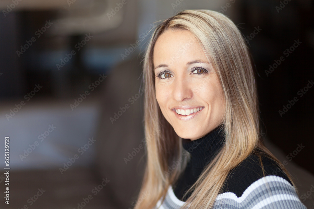 Fototapeta premium Portrait Of A Pretty Blond Woman Smiling At The Camera. She is a student. 