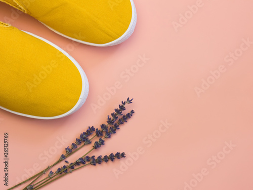 Yellow slip-on shoes on pink trendy background. Copy space for text. Women's shoes for every day. Concept of fashion and active lifestyle.