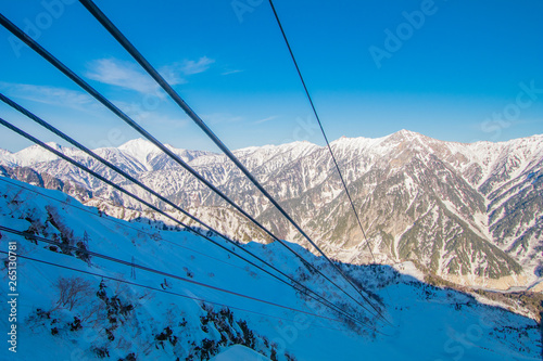 Cable car line of Tateyama Kurobe alpine in sunshine day with blue sky background is one of the most important and popular natural place in Toyama Prefecture, Japan.