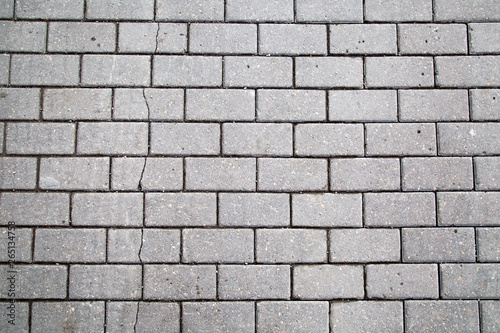 Background from grey artificial paving stone of rectangular shape. Backgrounds graphic design textures.