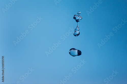 Water bubbles in the blue sky. Water drops on blue background. Aqua, rain, weather, clear. Life, freedom, ease. photo