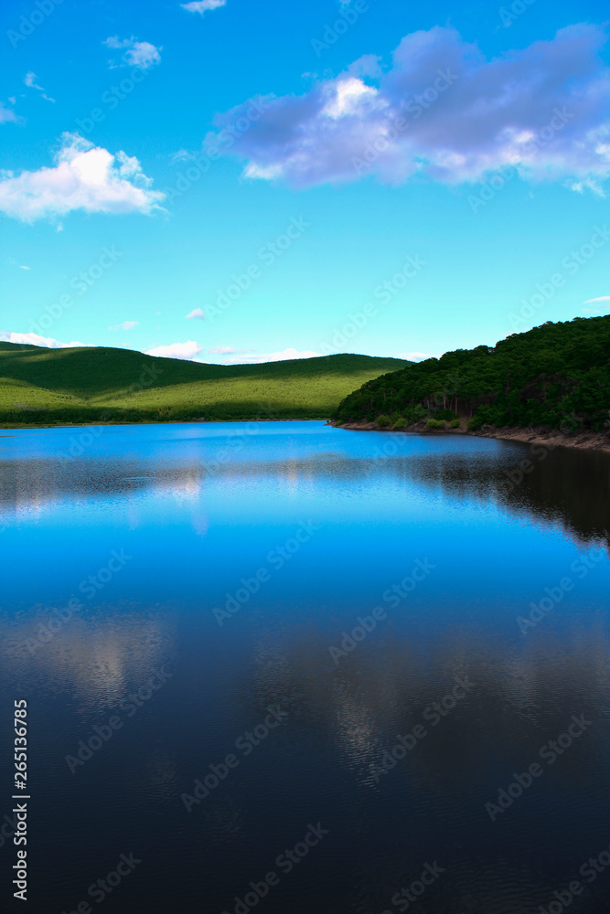 Beautiful lake with specular shine in soft  mountains 