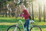 Teenager girl on a bicycle in the park.