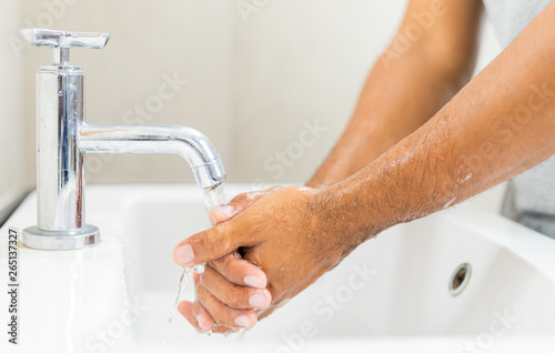 Man washing hands with soap.