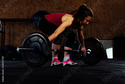 Woman having workout with weights in the gym