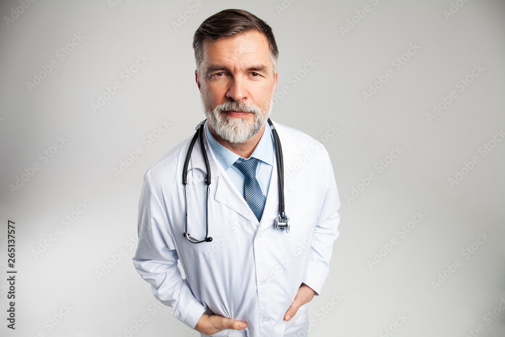 Cheerful mature doctor posing and smiling at camera, healthcare and medicine. Cheerful mature doctor posing and smiling at camera, healthcare and medicine.