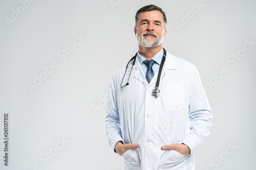Fototapeta Cheerful mature doctor posing and smiling at camera, healthcare and medicine