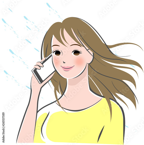 携帯電話をかけるロングヘアの女性