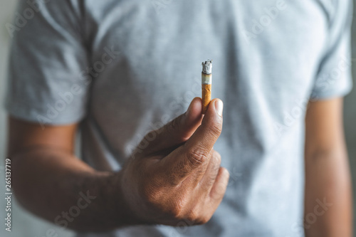Wallpaper Mural Close up male hand holding a cigarette. Torontodigital.ca