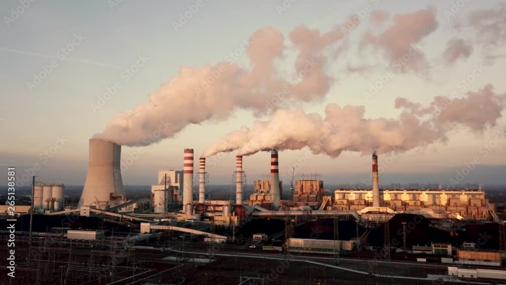 Dron shot of power station chimney producing smoke Dron shot of power station chimney producing smoke