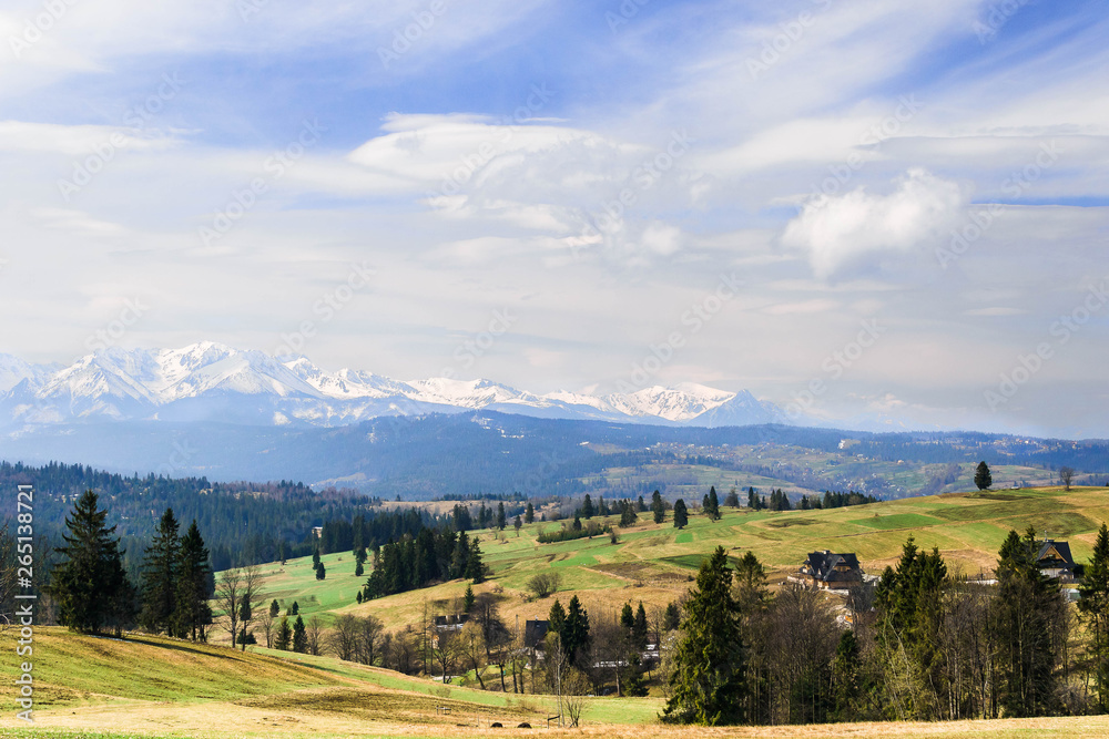 Beautiful landscape of Tatra Mountain covered with snow. View from the green hill.